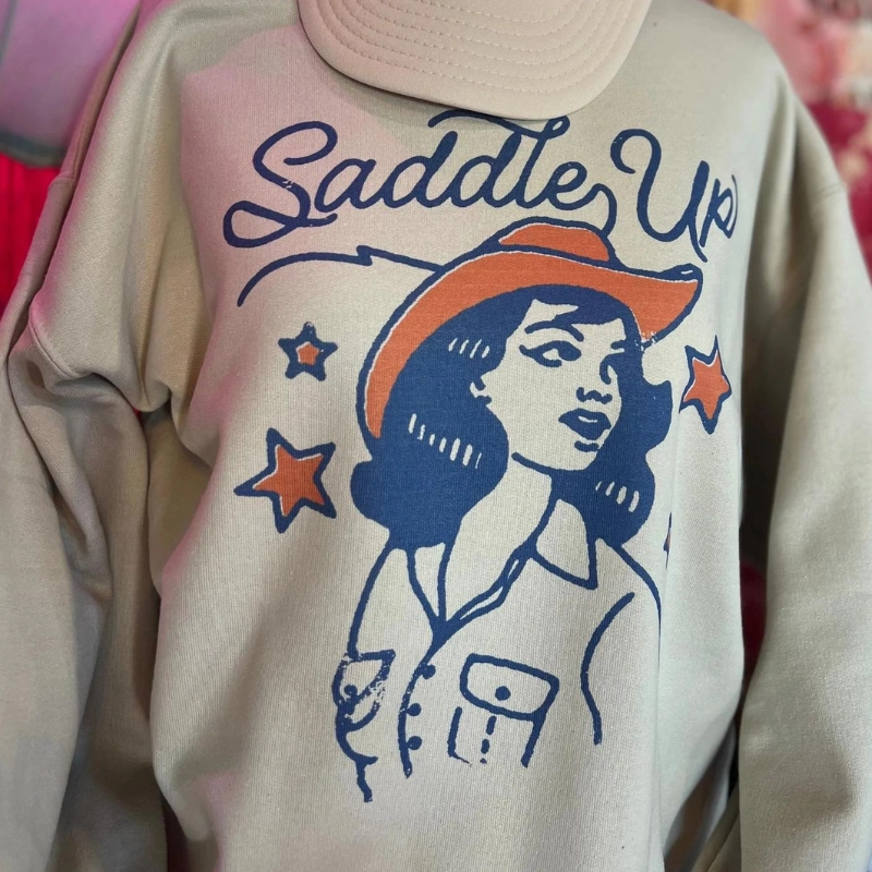 stain resistant coating Versatile Top Online Exclusive | Saddle Up Cowgirl Long Sleeve Graphic Sweatshirt in Cream