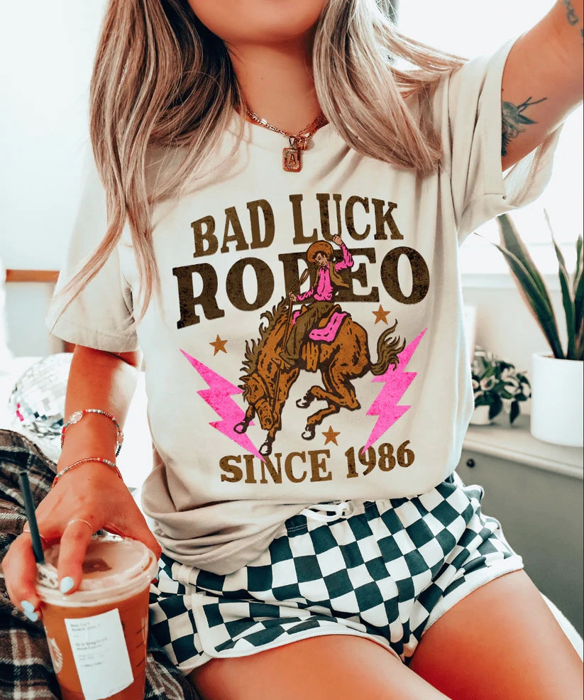 Trendy Vibe Simple and Comfortable Online Exclusive | Bad Luck Rodeo Short Sleeve Graphic Tee in Cream