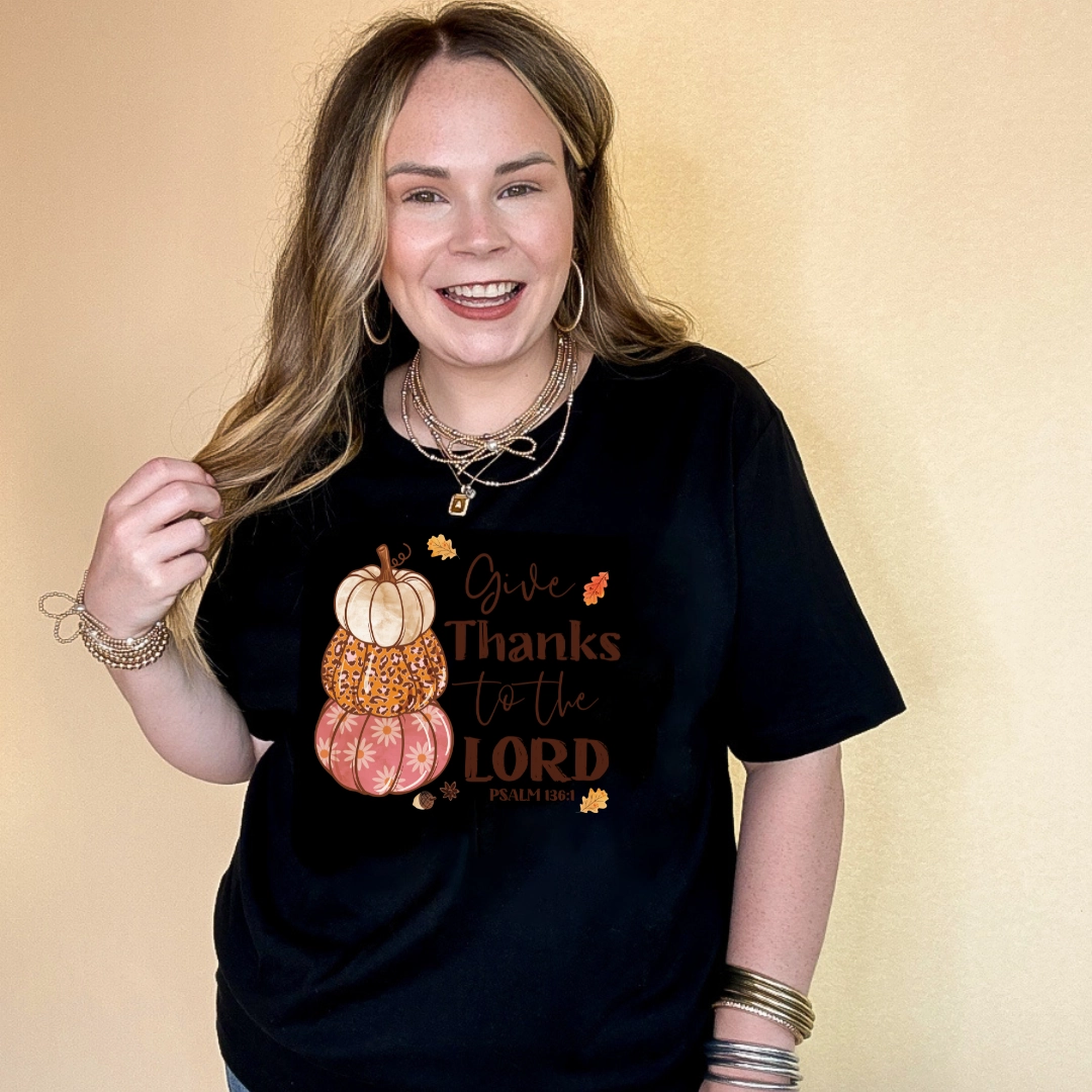 Online Exclusive | Give Thanks to the Lord Psalm 136:1 Stack of Pumpkins Graphic Tee in Multiple Color Options Chic Cut Outdoor Style Trend